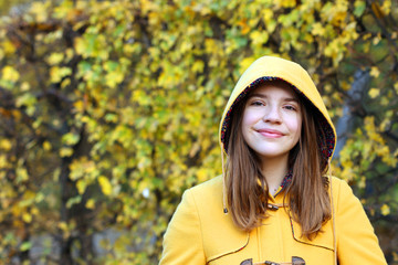 teenage girl in a yellow hooded coat portrait autumn season