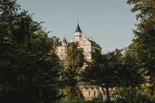 The view of the Radun castle in empire style, known landmark in Radun in Czech republic, above the castle pond during the sunny summer day with clear sky in background