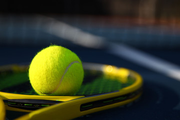Detail of a tennis ball on a racket that is blurred out