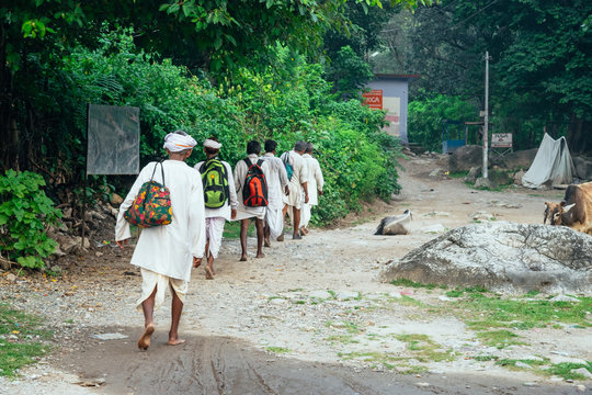 Elderly indus men walking with turbans on their heads and white clothes
