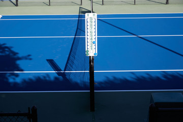 Tennis score keepers on the side of a tennis court