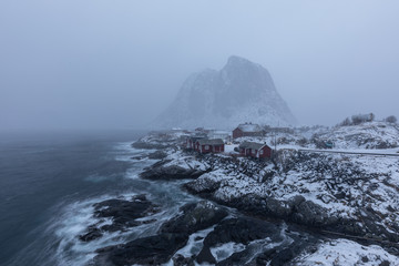 Beautiful traditional fishing red rorbuer huts in Hamnoy village during a storm. Lofoten Islands, Norway, Scandinavia.