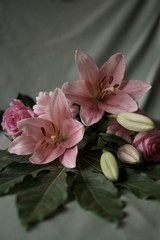 Background with bouquet with pink flowers, lilys, roses and gerbera daisy