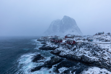 Beautiful traditional fishing red rorbuer huts in Hamnoy village during a storm. Lofoten Islands, Norway, Scandinavia.