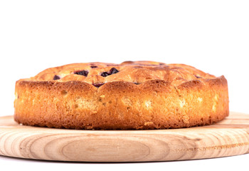 Close up. Pie with cherries on a cutting board isolated on a white background.