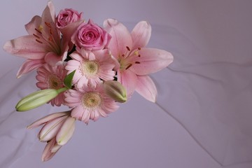 Background with bouquet with pink flowers, lilys, roses and gerbera daisy