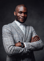 Foggy gray background. Black serious business person. A successful professional entrepreneur with gray background behind.