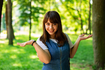 Caucasian white teenager girl emotional smiling face portrait photography in park outdoor environment space sunny weather day