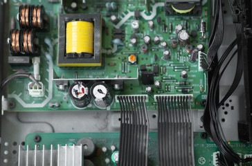 A close-up microchip with many electrical components placed on the Board. The background is blurred.