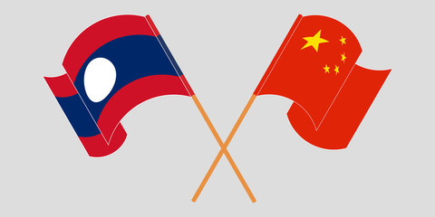 Crossed and waving flags of Laos and China