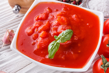 juicy canned tomatoes on wooden rustic background