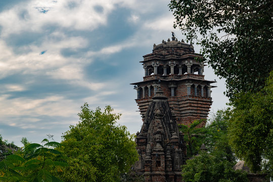 A landscape having a fortress with temple like dome in front and lush green trees around, situated at Pearl Hill, Udaipur, Rajasthan.