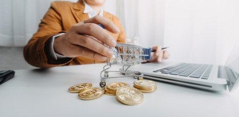 businesswoman holding coins putting in glass with using smartphone and calculator to calculate concept saving money for finance accounting
