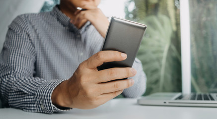 Business people use tablets and hold credit cards as an online shopping concept With a calculator and a book placed on the table