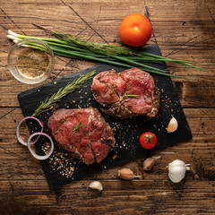 a piece of meat and vegetables on a black slate Board - 372064536