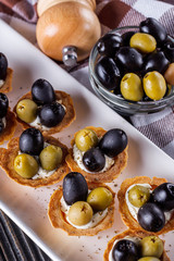 delicious snack tartlets on rustic wooden background