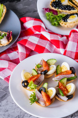 delicious snack tartlets on dark stone background