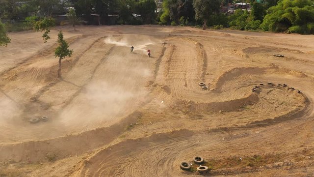 Motorcycle racers on the motocross track, ride off-road and jump over sand hills.. Cagayan de Oro, Mindanao, Philippines.
