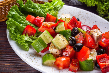 greek salad on dark wooden rustic background