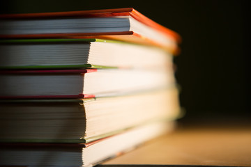 Close-up of a stack of books. The concept of home reading of paper books, school education and Institute, back to school. Space for text, background.