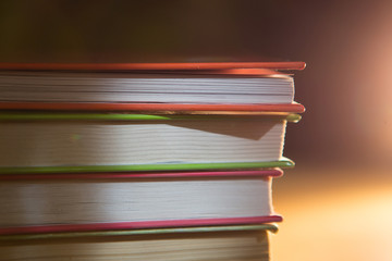 Close-up of a stack of books. The concept of home reading of paper books, school education and Institute, back to school. Space for text, background.
