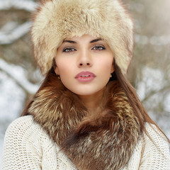 Winter portrait of beautiful woman in fury hat