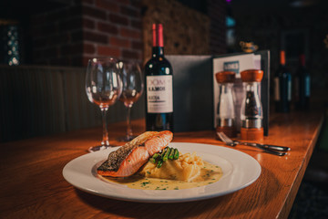 Salmon and potatoes served with cream sauce