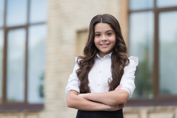 Fototapeta premium Tradition of confidence. Confident kid keep arms crossed. Confident look of school girl. Fashion uniform trend. Back to school. Formal education. September 1. Confident in knowledge, copy space