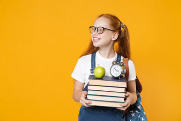 Young fun redhead girl 12-13 years old in white t-shirt eyeglasses backpack hold big stack school...