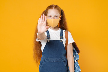 Young redhead school teen kid girl 12-13 years old in white tshirt face mask backpack isolated on yellow background children studio portrait Distance education at home quarantine covid-19 ncov concept