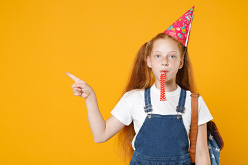 Happy fun redhead school teen kid girl 12-13 years old in birthday hat white t-shirt blue uniform...