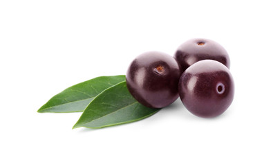 Fresh acai berries with leaves isolated on white