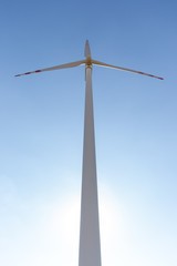 Wind turbine under blue sky in summer, renewable energy concept photo