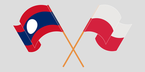 Crossed and waving flags of Laos and Poland