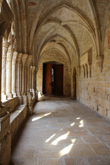Vaulted galleries of the courtyard and the ancient door of the monastery of Poblet (cat. Reial Monestir de Santa Maria de Poblet) Spain.