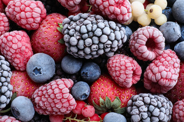 Mix of different frozen berries as background, top view