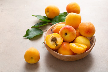 Fresh golden apricot on stone table close up