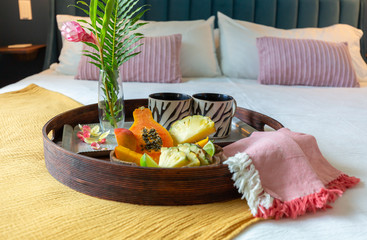 Tropical fruit tray on bed