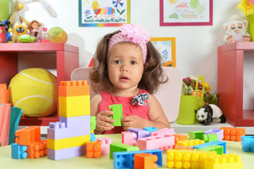 Fototapeta premium Portrait of little baby girl with toys