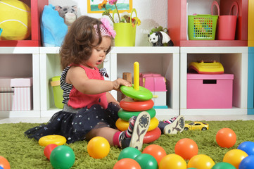 Portrait of cute little baby girl playing