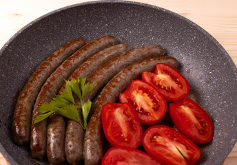 fried natural beef sausage and tomatoes