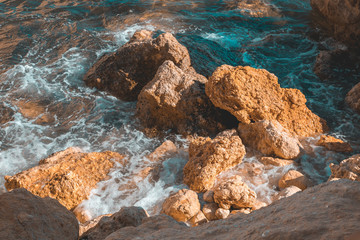 Sea waves beating against rocks on the beach