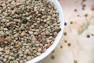 natural and organic green dry lentils, dry lentils in a plate,