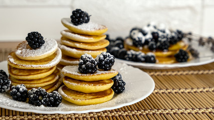 Pancakes served with black currant and blackberry. Dessert and breakfast concept