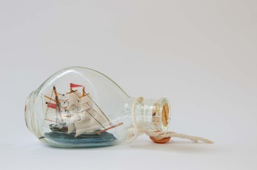 Ship in a bottle. Glass sailing ship background.