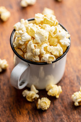 Sweet tasty popcorn in mug.