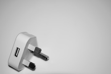 Isolated British electric plug, white background.
