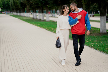 Obraz premium young couple walking in the park steadicam shot