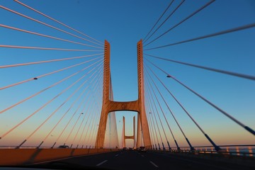 Fototapeta na wymiar suspension bridge at sunset Lisbon Vasco da Gama
