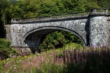 Fototapeta na wymiar Ancient Stone Bridge Over a Highland River in Scotland